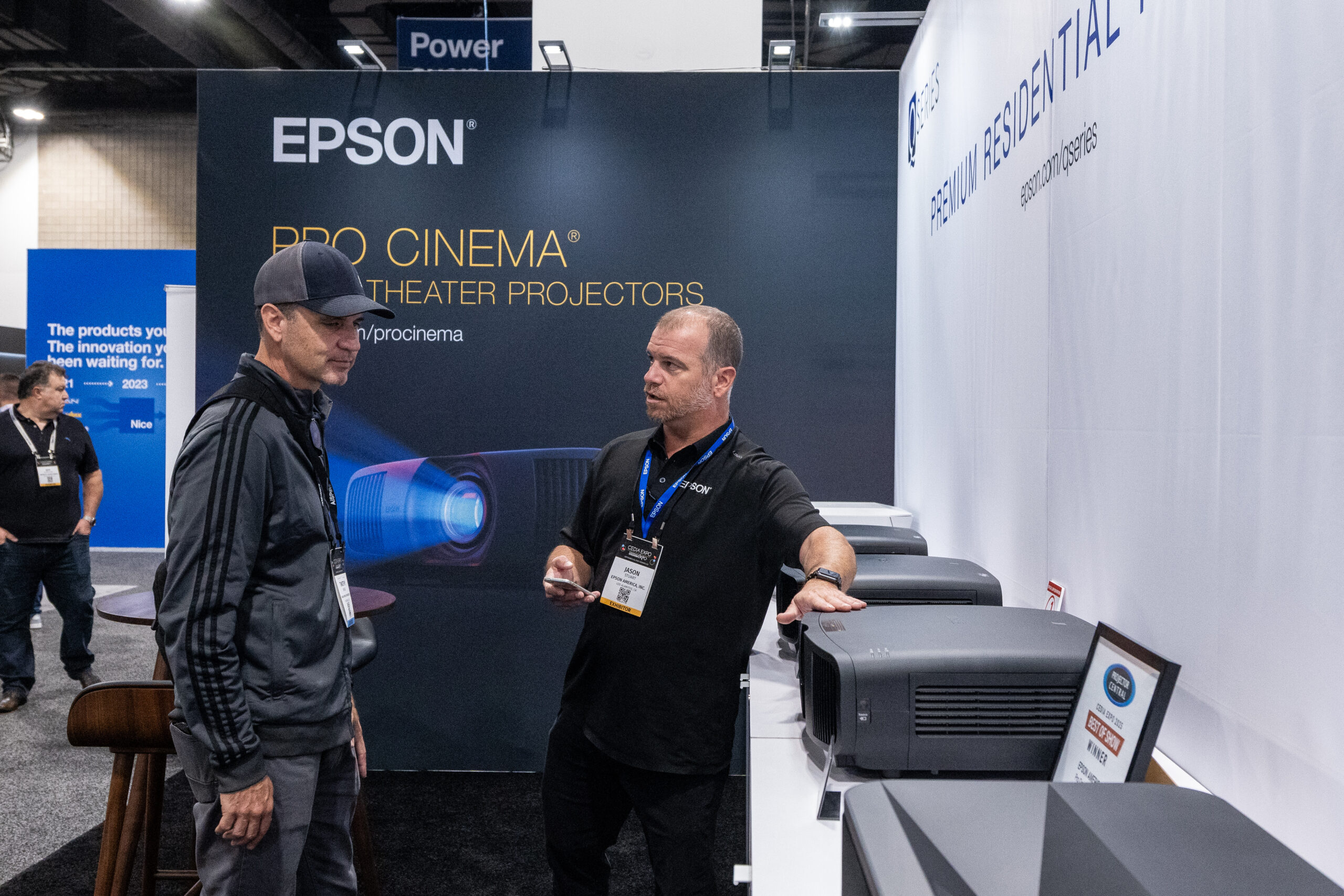 Attendee and exhibitor demonstrating a new product at CEDIA Expo/CIX