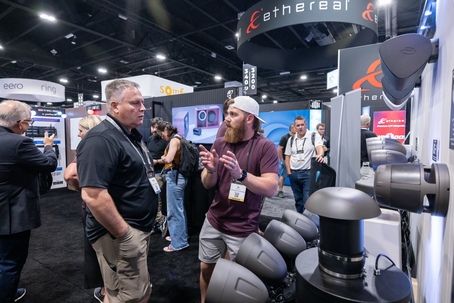 Attendee and exhibitor discussing a new product at Ethereal booth at CEDIA Expo/CIX