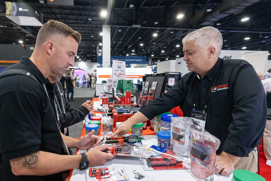 Attendee at CEDIA Expo/CIX viewing a new commercial product from SimplyBrands.