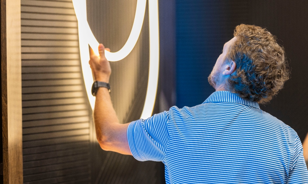 Integrator at CEDIA Expo/CIX examining lighting fixtures on the show floor.